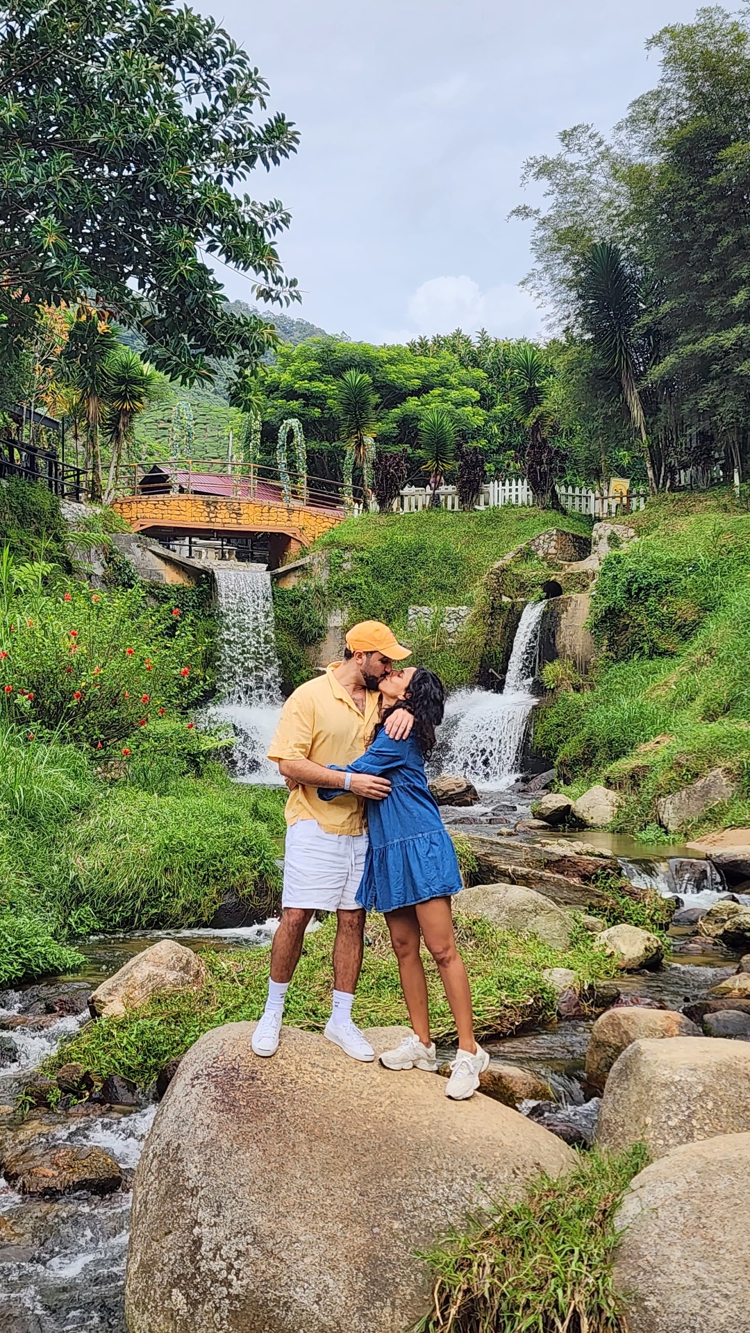 Simon and Rachel kissing at a waterfall